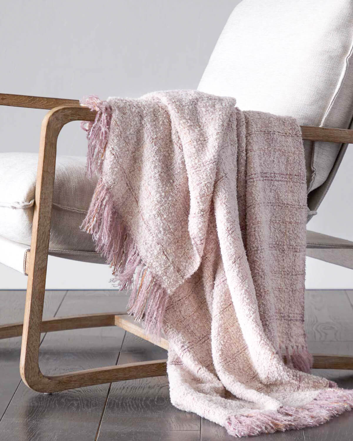 
                  
                    Pink Cariño Alpaca Throw draped over accent chair. Handwoven textiles from Peru.
                  
                
