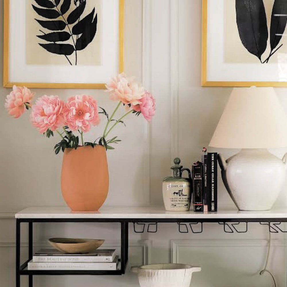 
                  
                    Red terracotta clay vase styled in entryway with pink flowers. Photo via @damaandwood
                  
                
