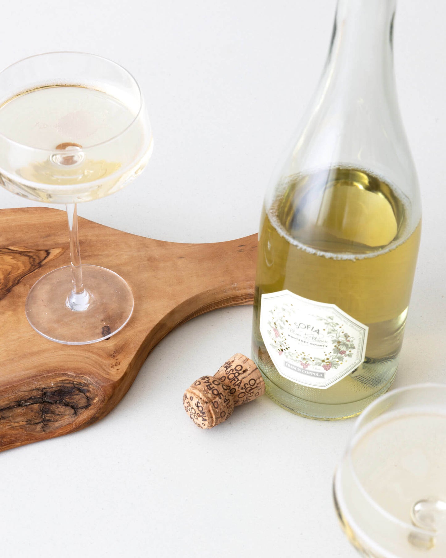 
                  
                    Fairkind's Sousse Serving Board with champagne and glasses.
                  
                