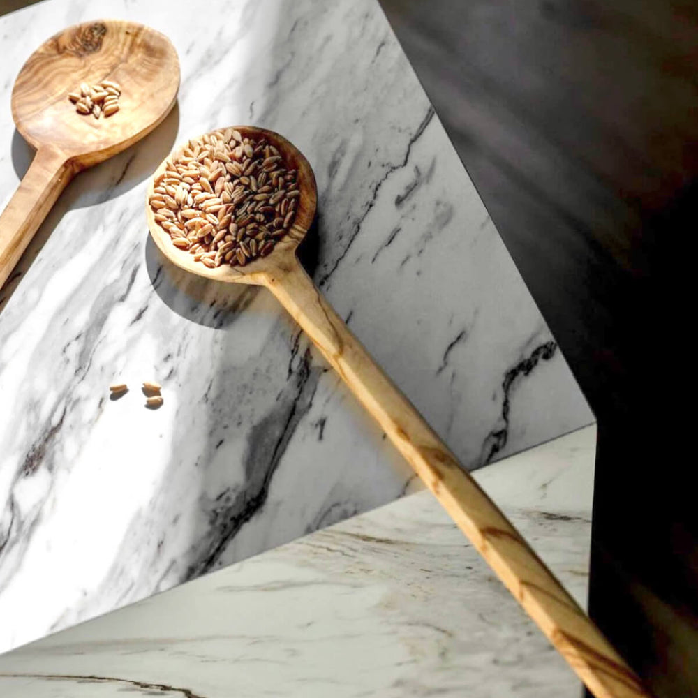 
                  
                    Premium olive wood serving spoons on marble pedestal table with shadow cast. Photo via @willowstyleco
                  
                