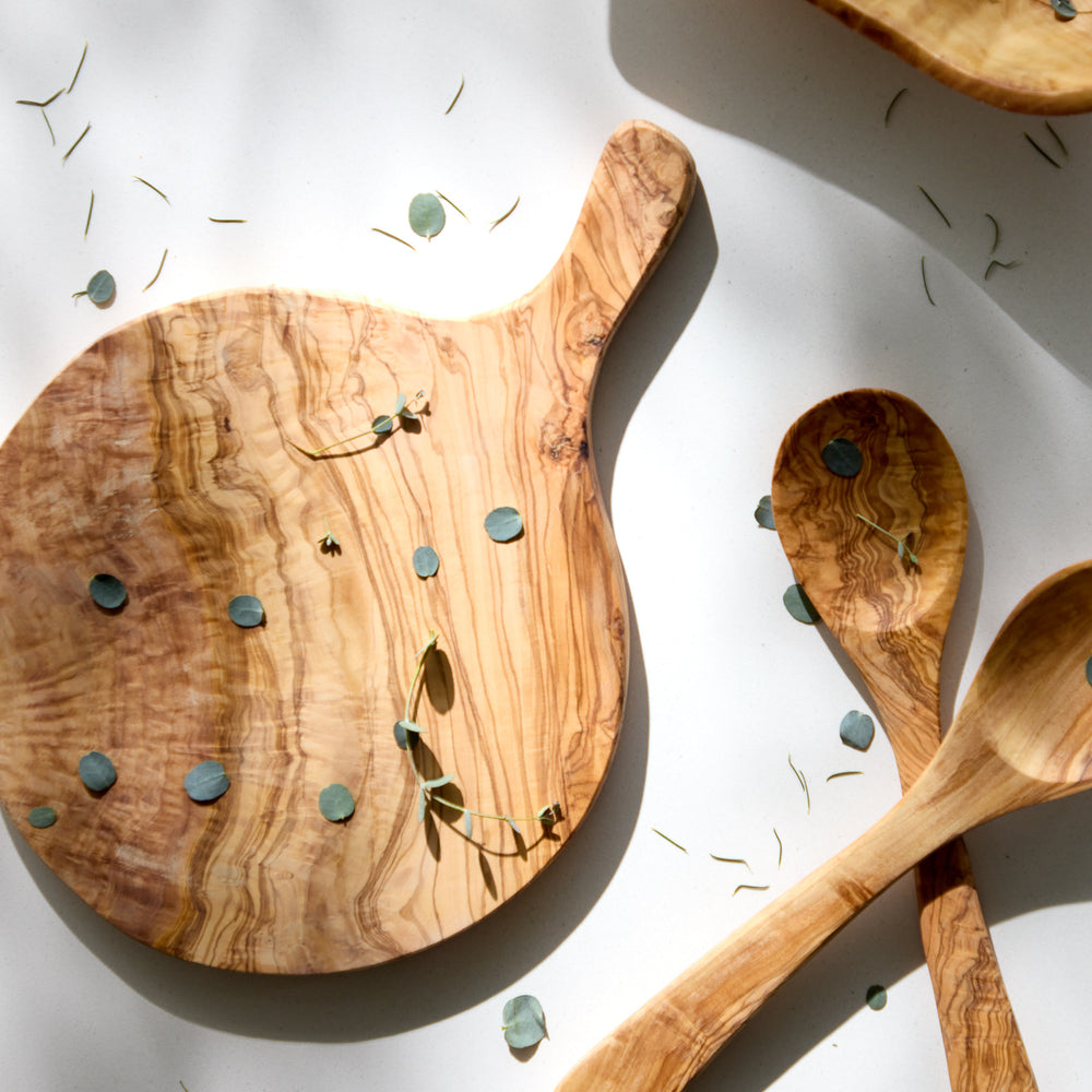 
                  
                    Handcrafted olive wood cheese board with handle.
                  
                