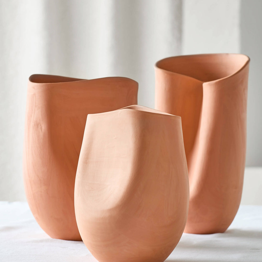 Tahj Terracotta Vases on white table. Handcrafted terracotta clay with sculptural design.