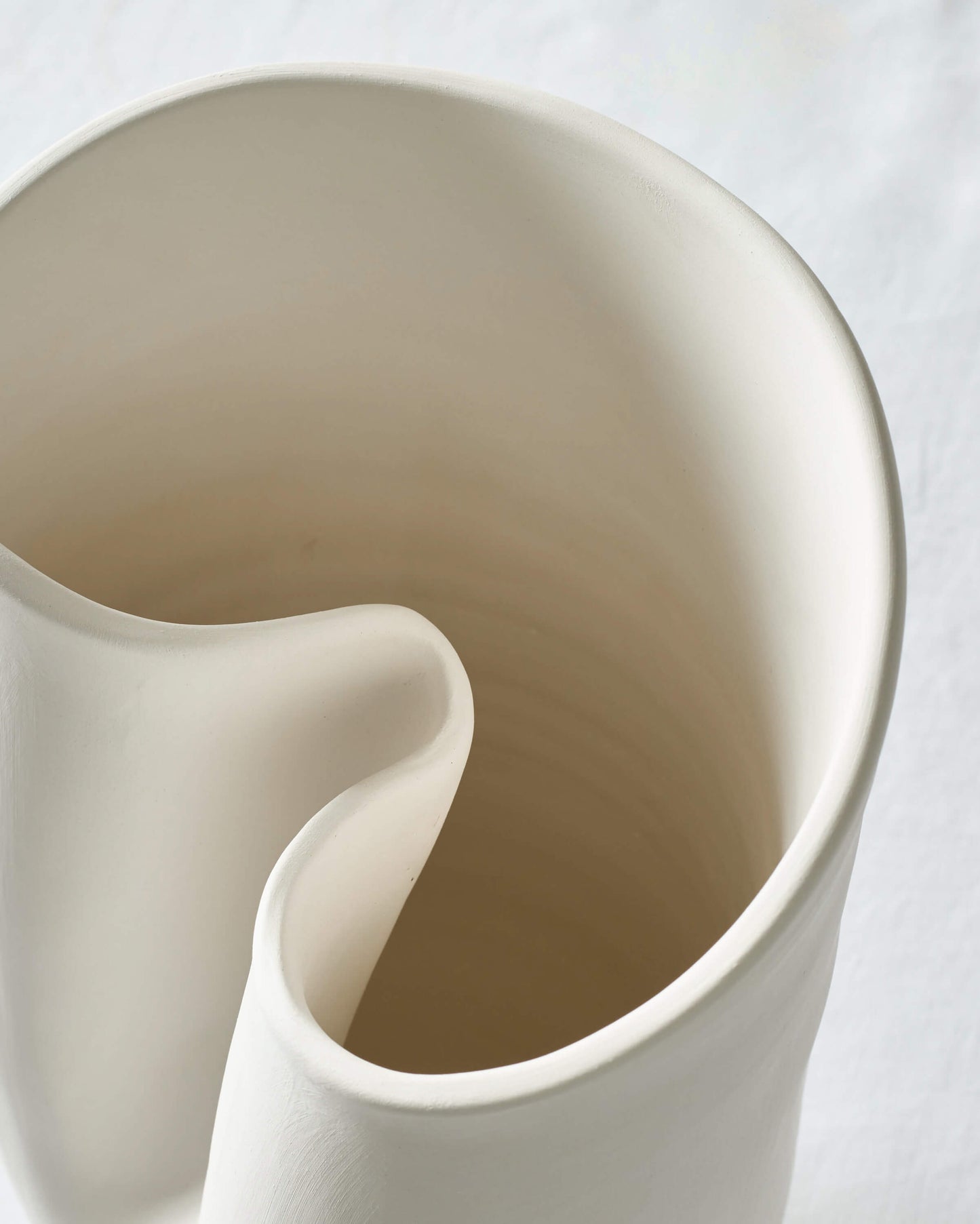 
                  
                    Close-up of the large Zoya Vase's curved edge detail and sculptural design.
                  
                