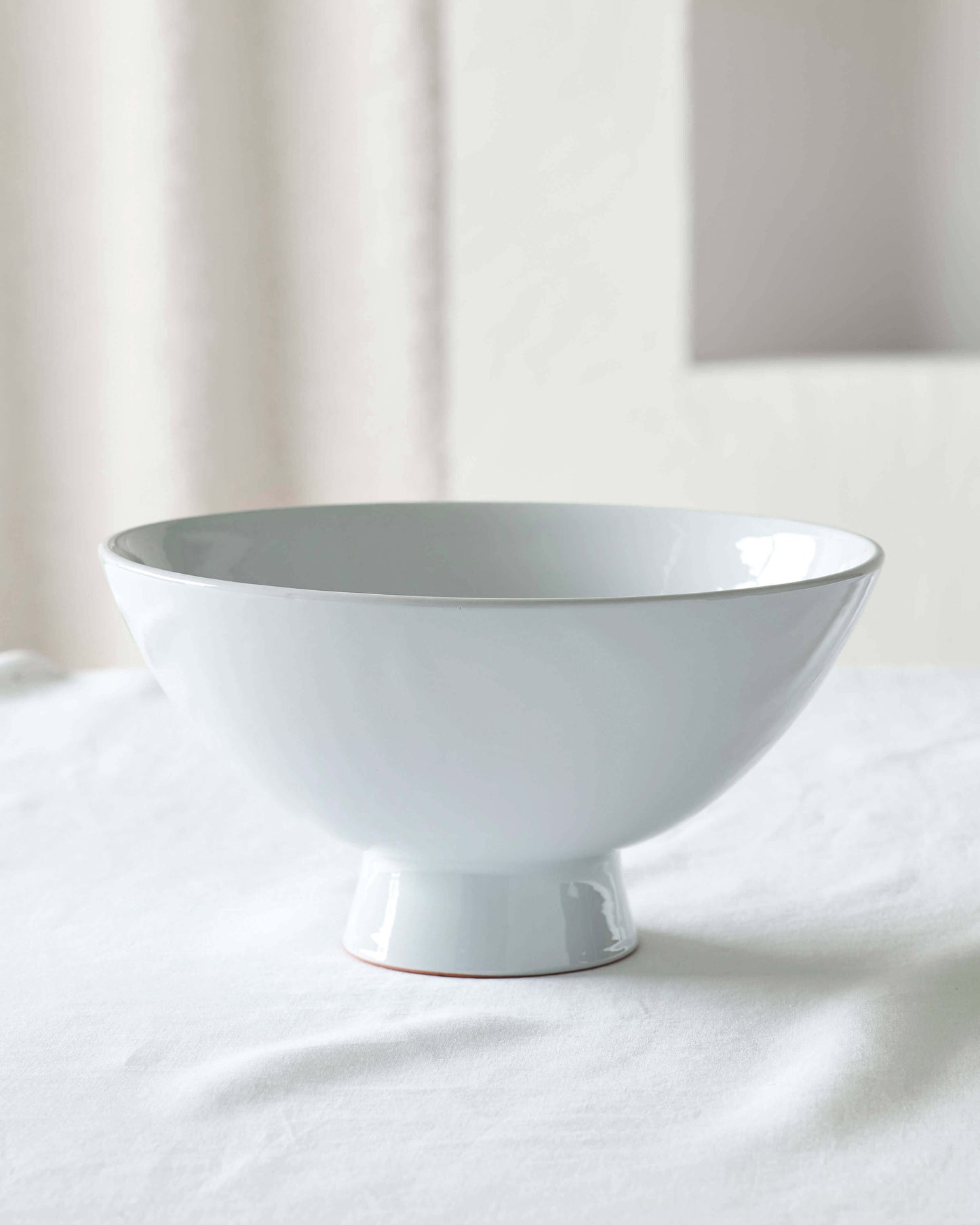 
                  
                    Light gray Rami Pedestal bowl, handmade ceramics by Fairkind.
                  
                