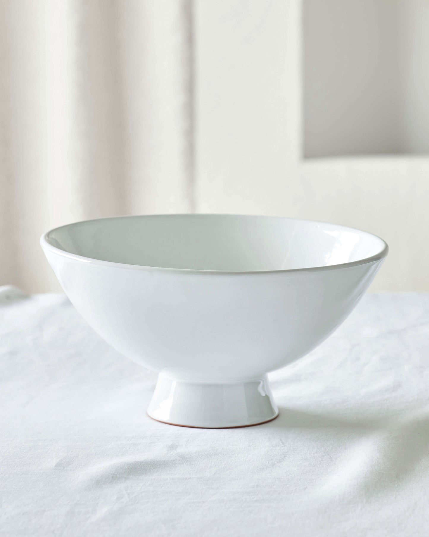 White glossy Rami Pedestal Bowl by Fairkind.