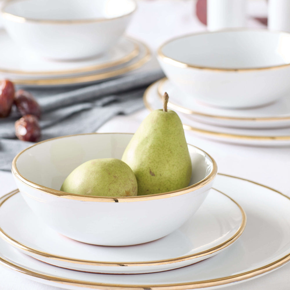 Fairkind's Fez Gold-Rimmed Dinnerware styled on a white table with pears.