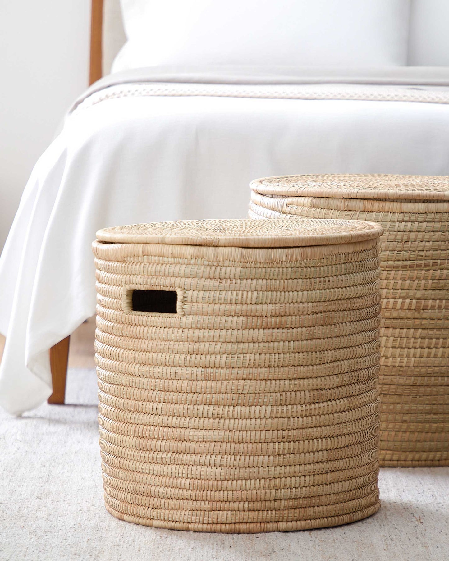 
                  
                    Handwoven storage baskets at foot of bed. Salima baskets by Fairkind.
                  
                
