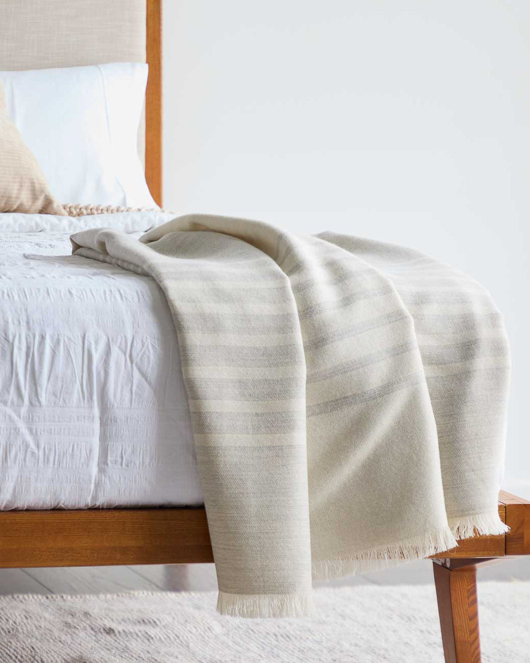 Beautiful luxury gray and white striped Fairkind baby alpaca throw blanket ethically sourced and handmade in Peru.