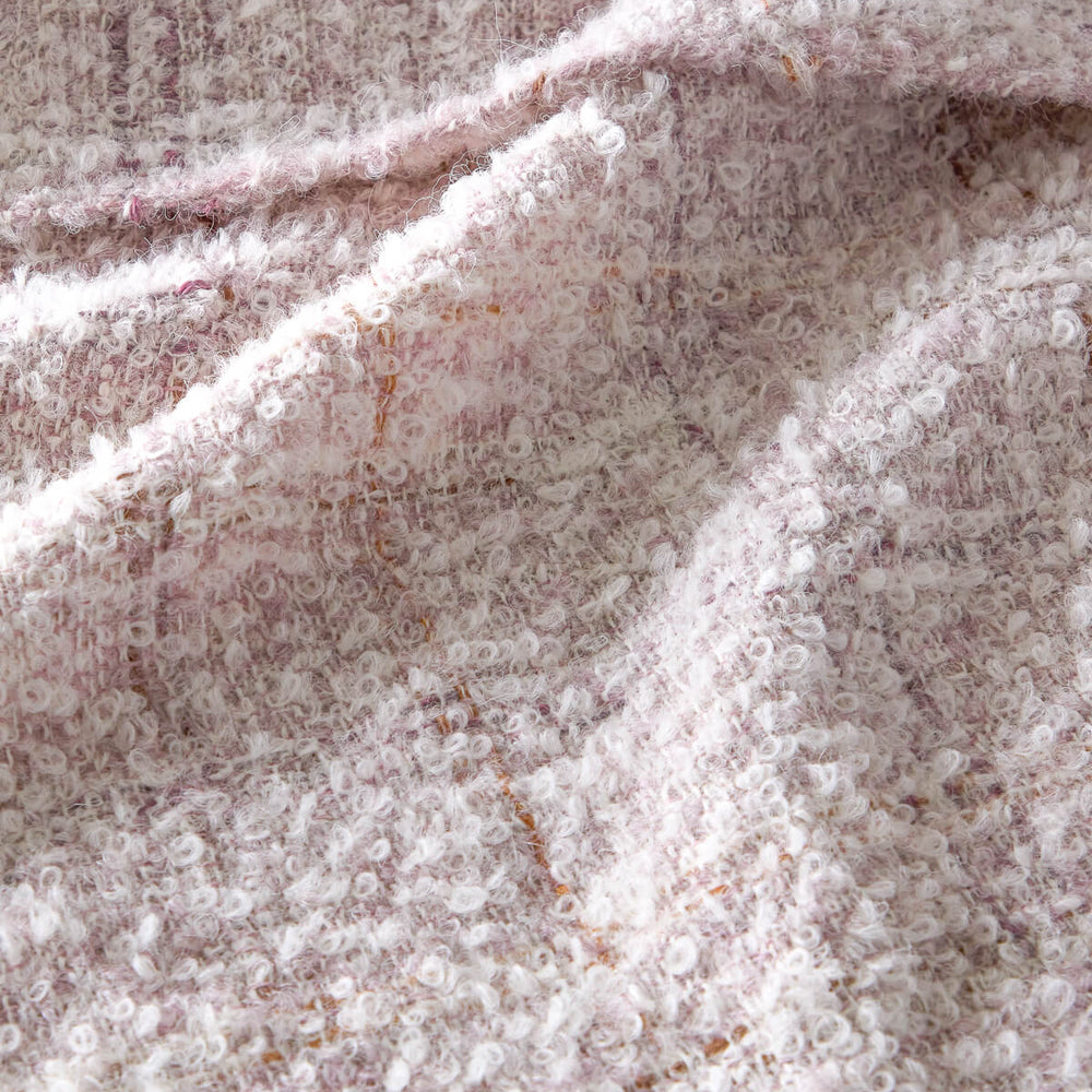 
                  
                    Cariño Fairkind boucle alpaca throw texture detail.
                  
                