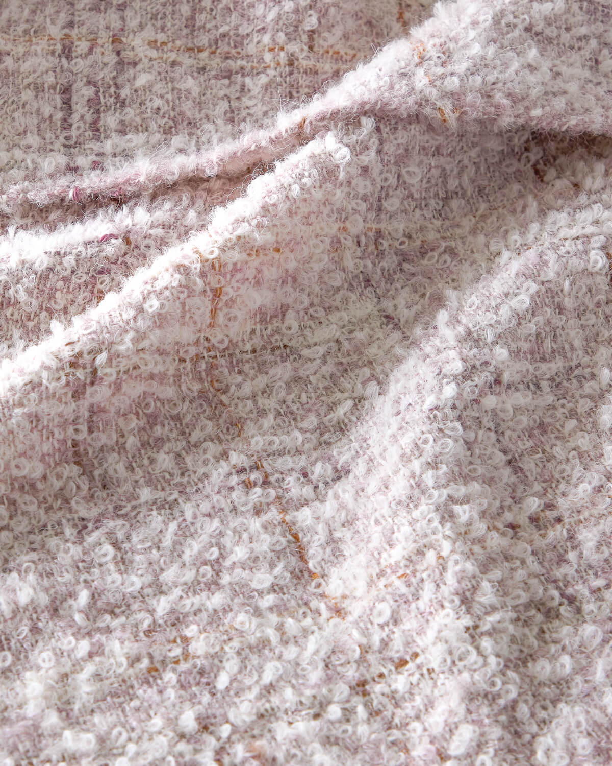 
                  
                    Cariño Fairkind boucle alpaca throw texture detail.
                  
                