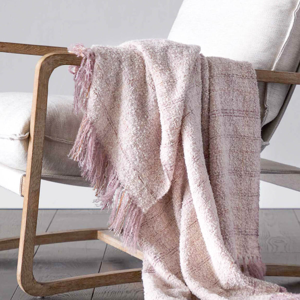 
                  
                    Pink Cariño Alpaca Throw draped over accent chair. Handwoven textiles from Peru.
                  
                