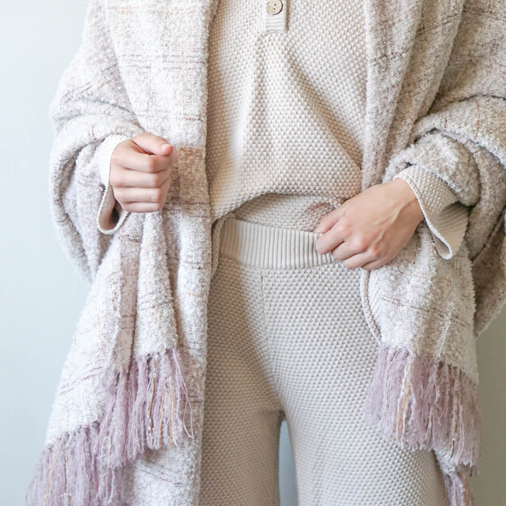 
                  
                    The Cariño Alpaca Throw wrapped on a model. Chunky boucle textured scarf or throw blanket.
                  
                