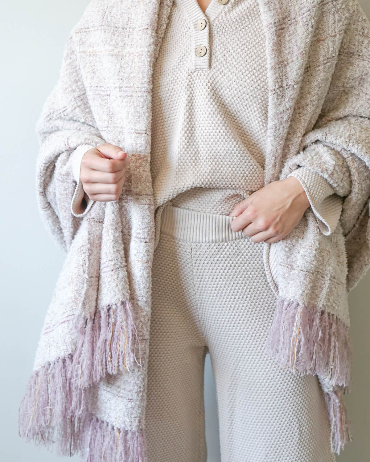 
                  
                    The Cariño Alpaca Throw wrapped on a model. Chunky boucle textured scarf or throw blanket.
                  
                