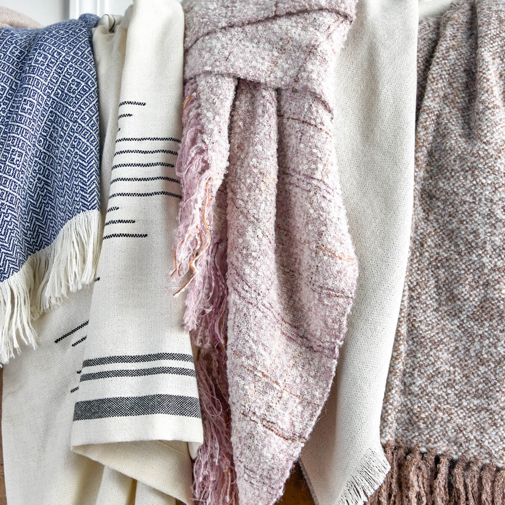 
                  
                    Soft boucle 100% alpaca throw hanging over dresser. Holiday gifts by Fairkind.
                  
                