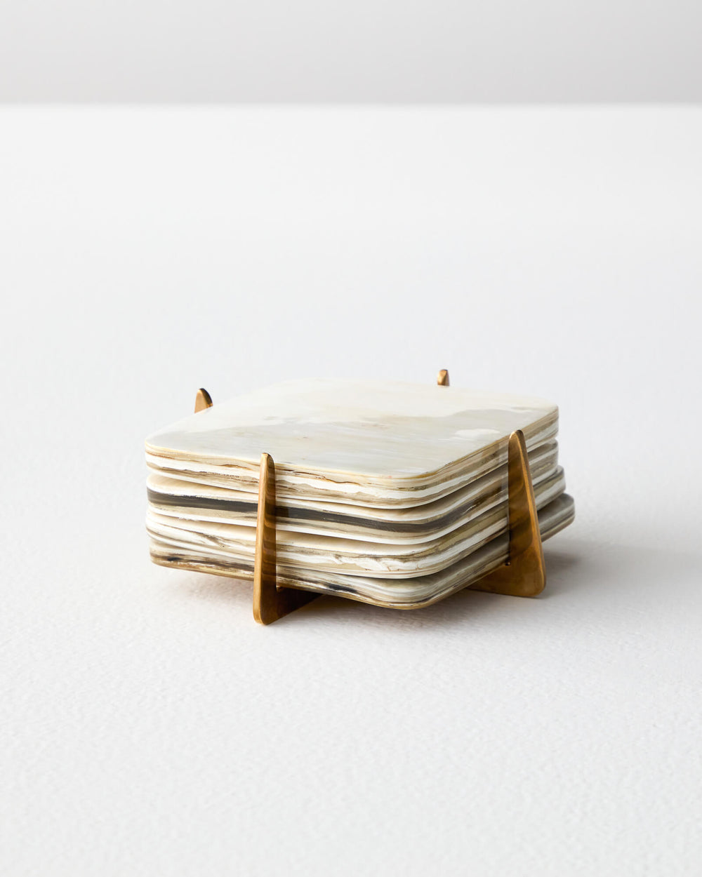 Zuri coaster set by Fairkind made with recycled horn and pure brass.