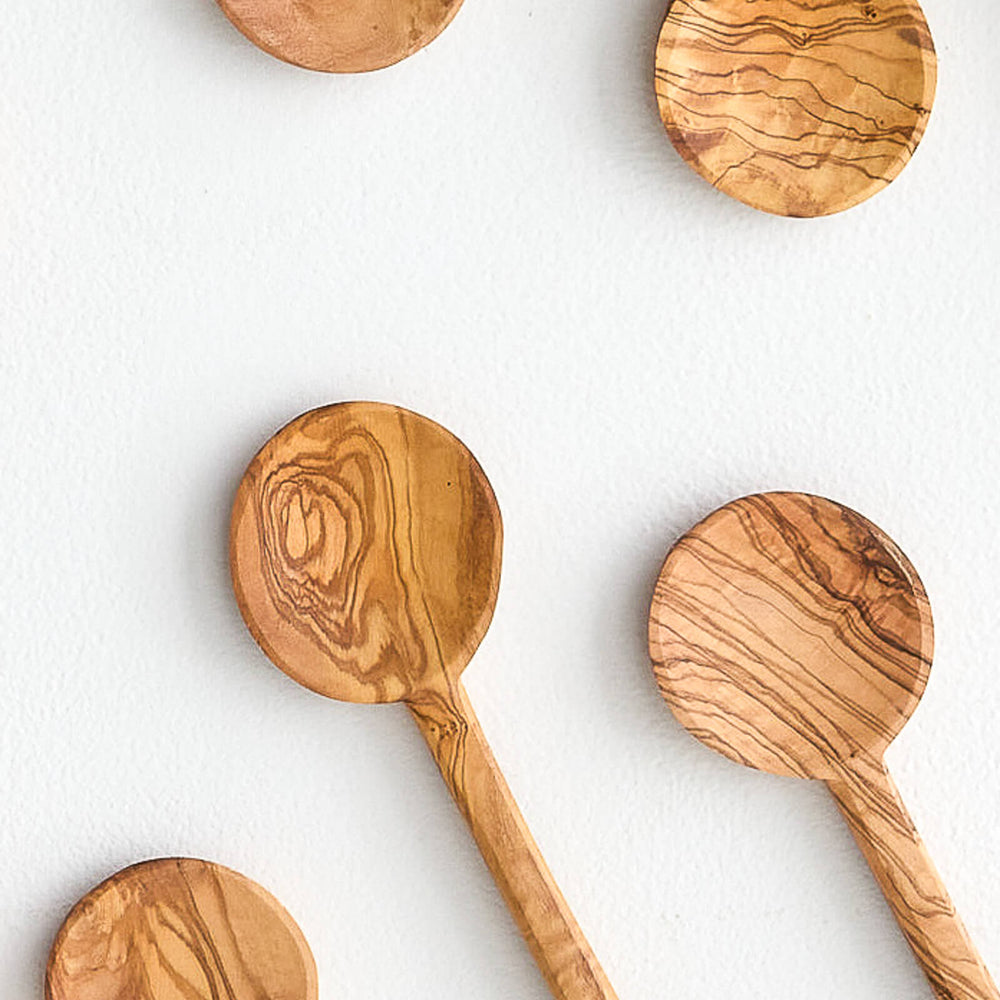 Close up of modern, round olive wood cooking spoons. Handmade in Tunisia.