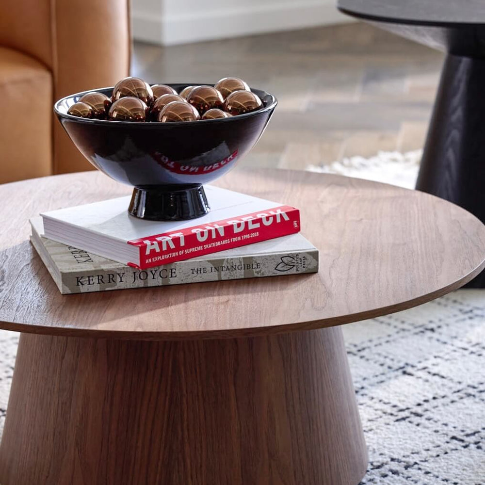 
                  
                    Close up of the Rami Pedestal Bowl in black with metallic decorative balls styled for holiday interiors.
                  
                