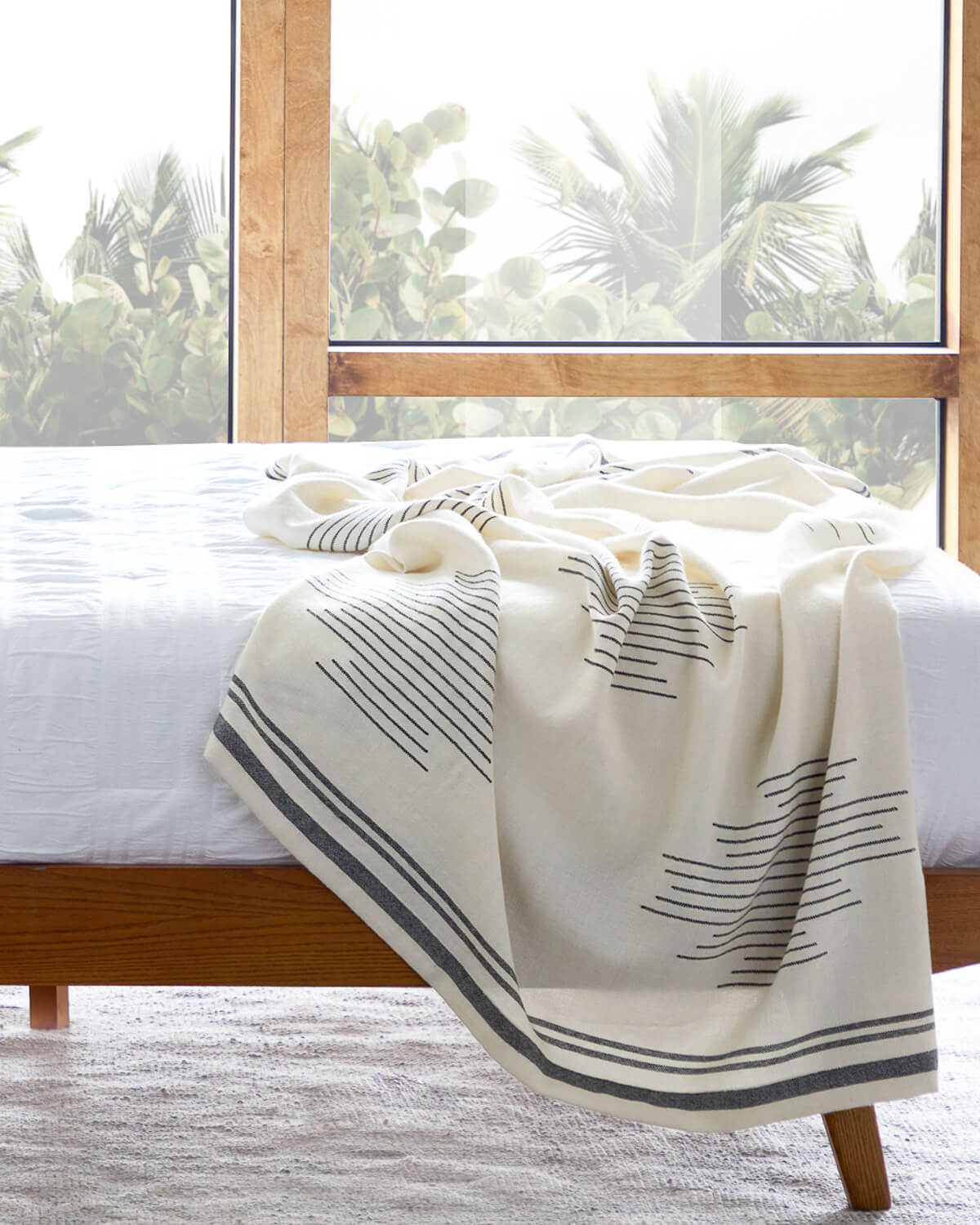 
                  
                    Luxury white and black alpaca throw blanket in modern bedroom.
                  
                