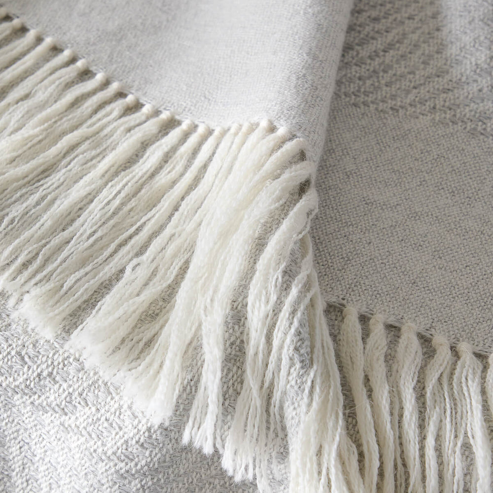 Detail of Fairkind La Loma alpaca throw blanket white fringe super soft and ethically sourced.
