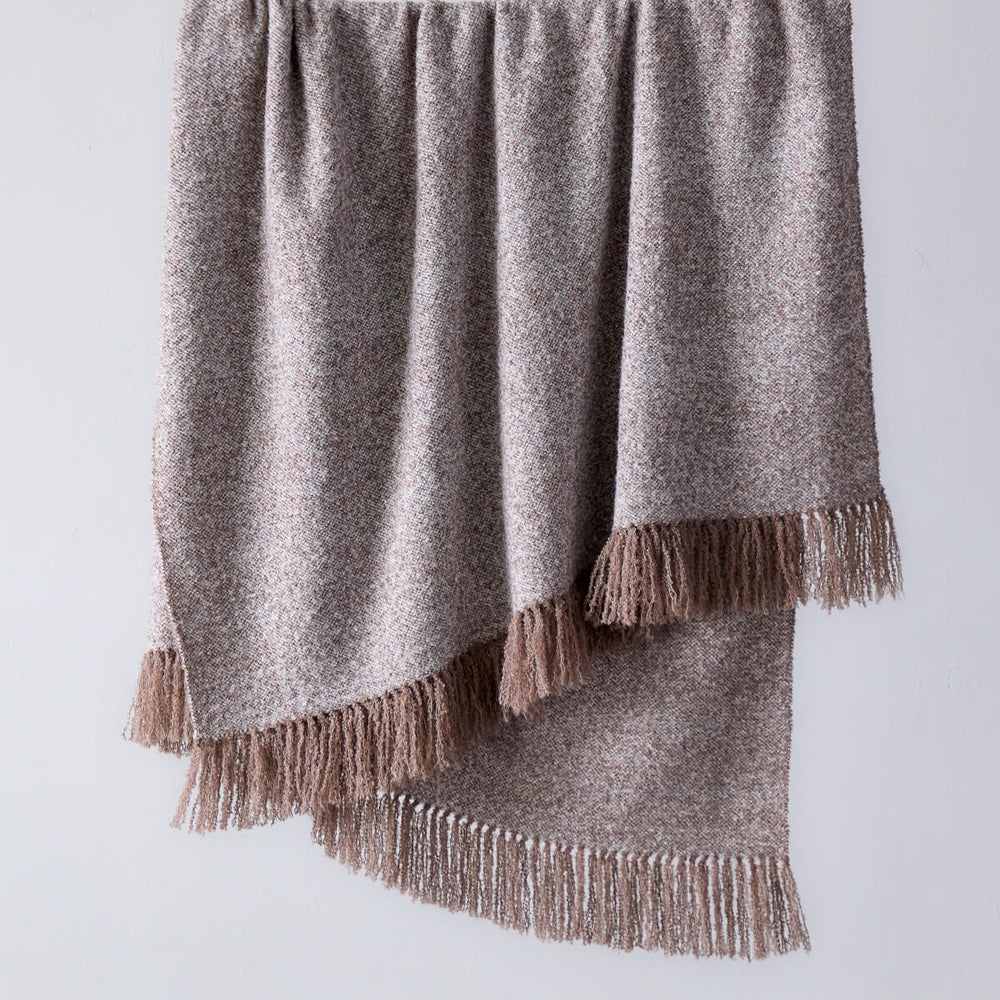 
                  
                    Fairkind La Tierra chestnut brown chunky boucle alpaca throw blanket with fringe.
                  
                