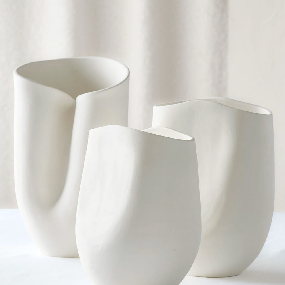
                  
                    Zoya Terracotta Vases by Fairkind. Raw white clay vases with curved sculptural designs, handmade in Morocco.
                  
                