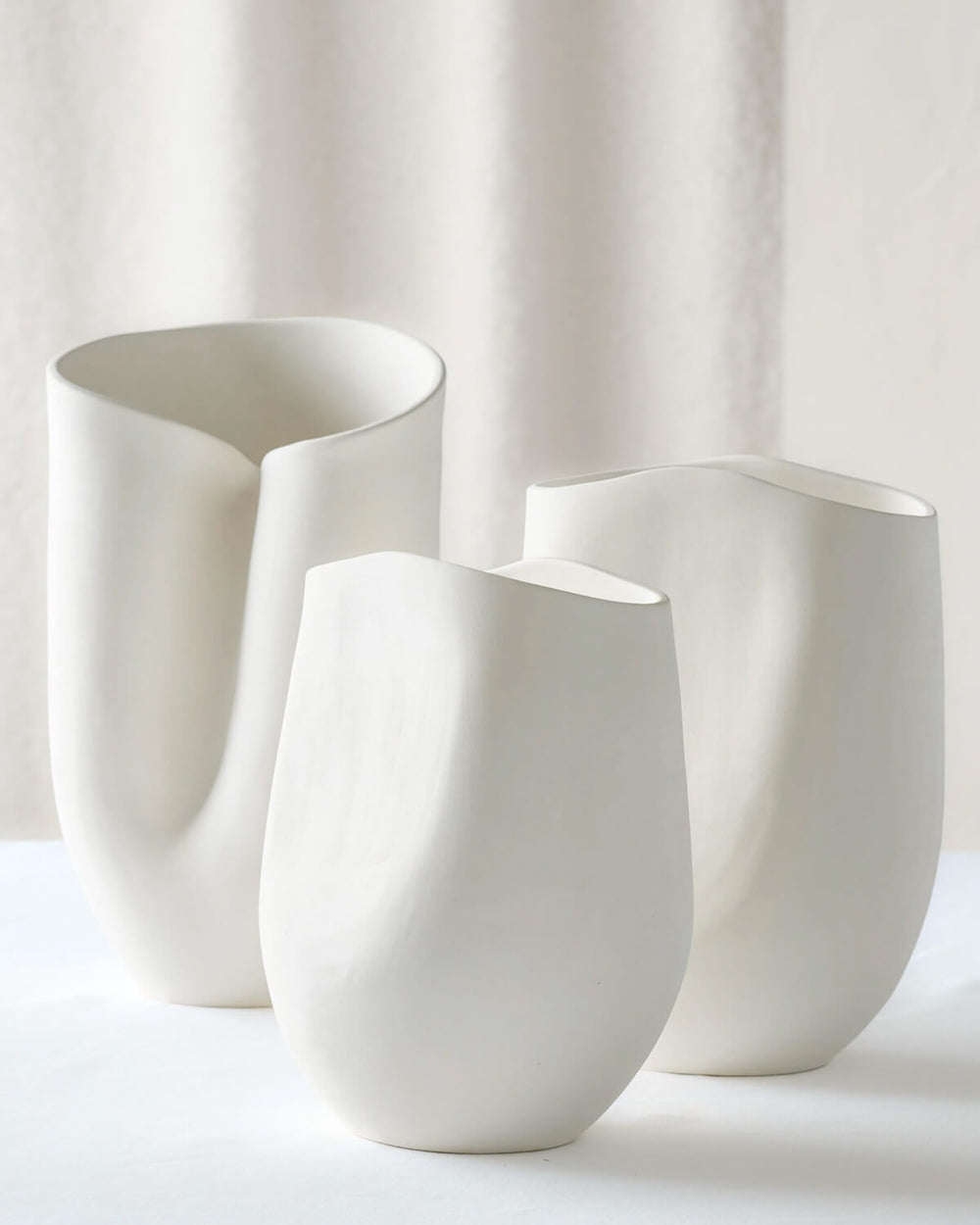 Zoya Terracotta Vases by Fairkind. Raw white clay vases with curved sculptural designs, handmade in Morocco.