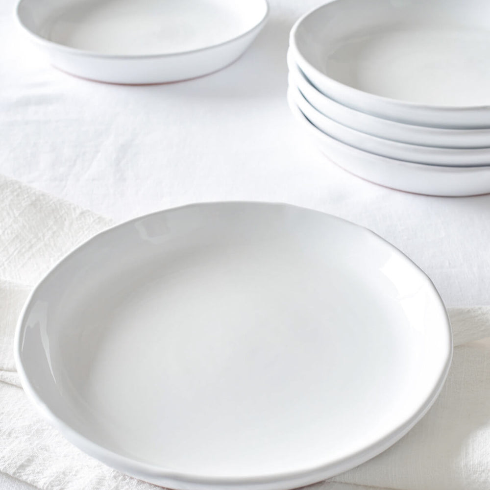 Khira Salad Plates stacked on white table. Part of the Fairkind Morocco Ceramic Collection.