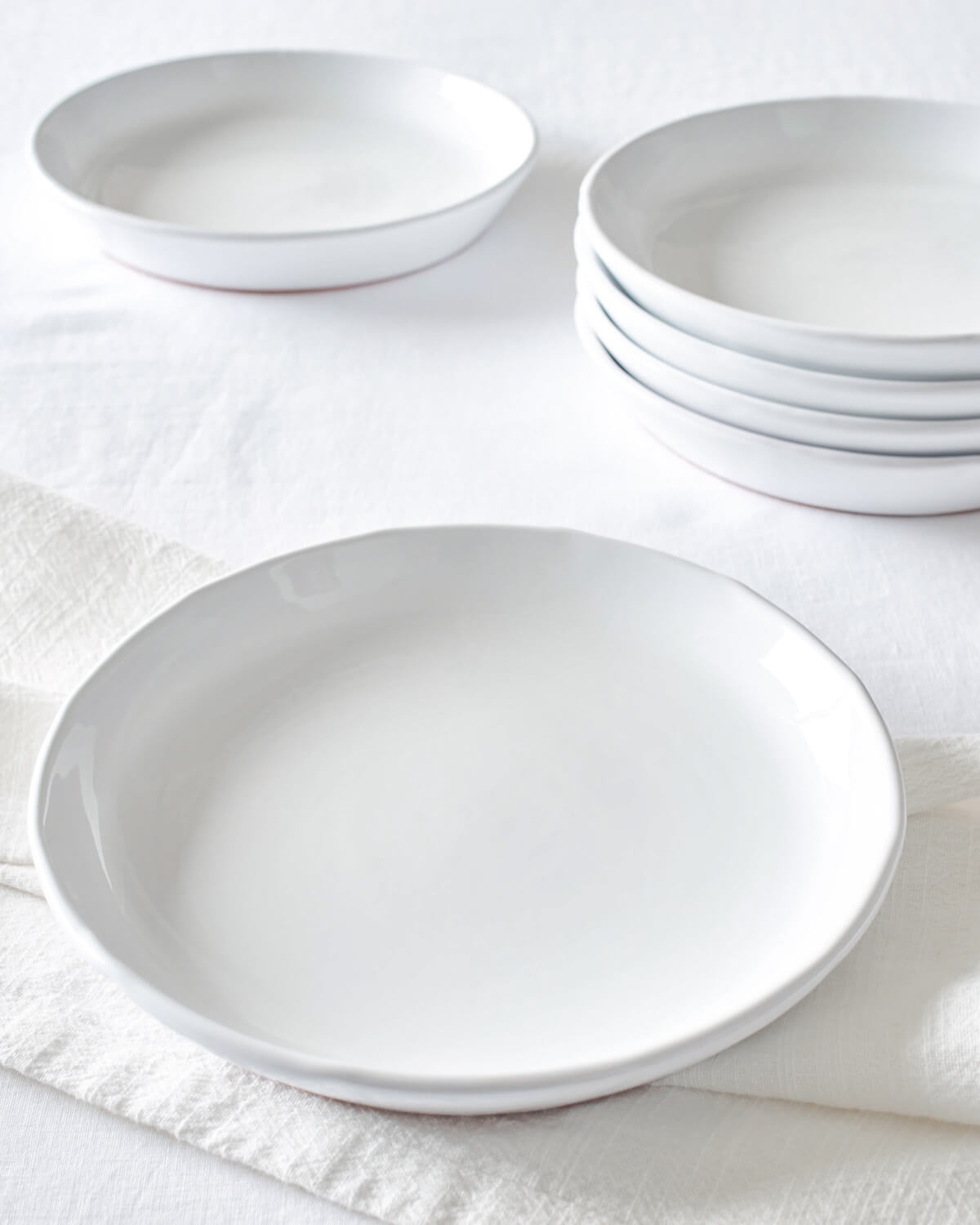 
                  
                    Khira Salad Plates stacked on white table. Part of the Fairkind Morocco Ceramic Collection.
                  
                