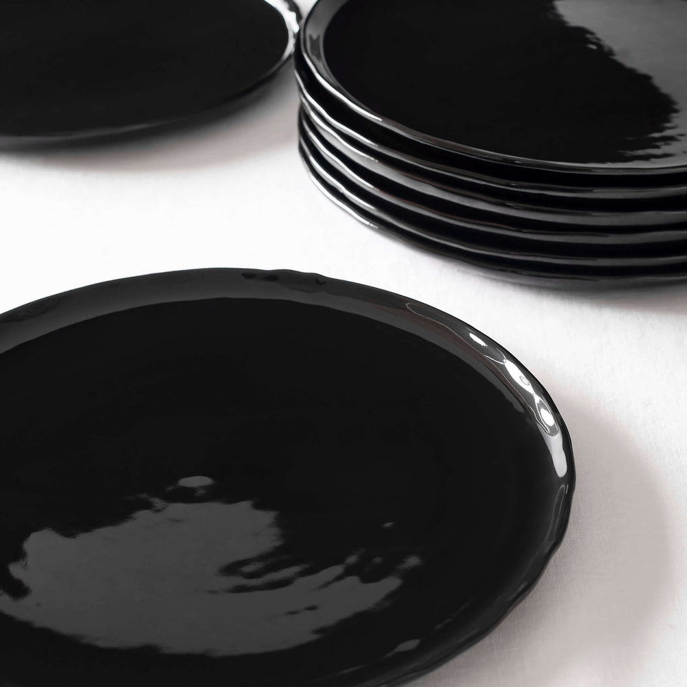 Black glossy handmade ceramic dinner plates by Fairkind.