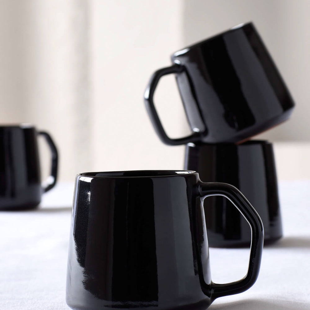 
                  
                    Modern, black Riad Mugs handcrafted in Morocco by master ceramists. Part of the Riad Dinnerware collection by Fairkind.
                  
                
