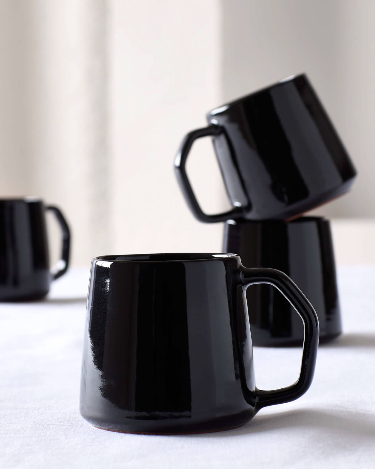 
                  
                    Modern, black Riad Mugs handcrafted in Morocco by master ceramists. Part of the Riad Dinnerware collection by Fairkind.
                  
                