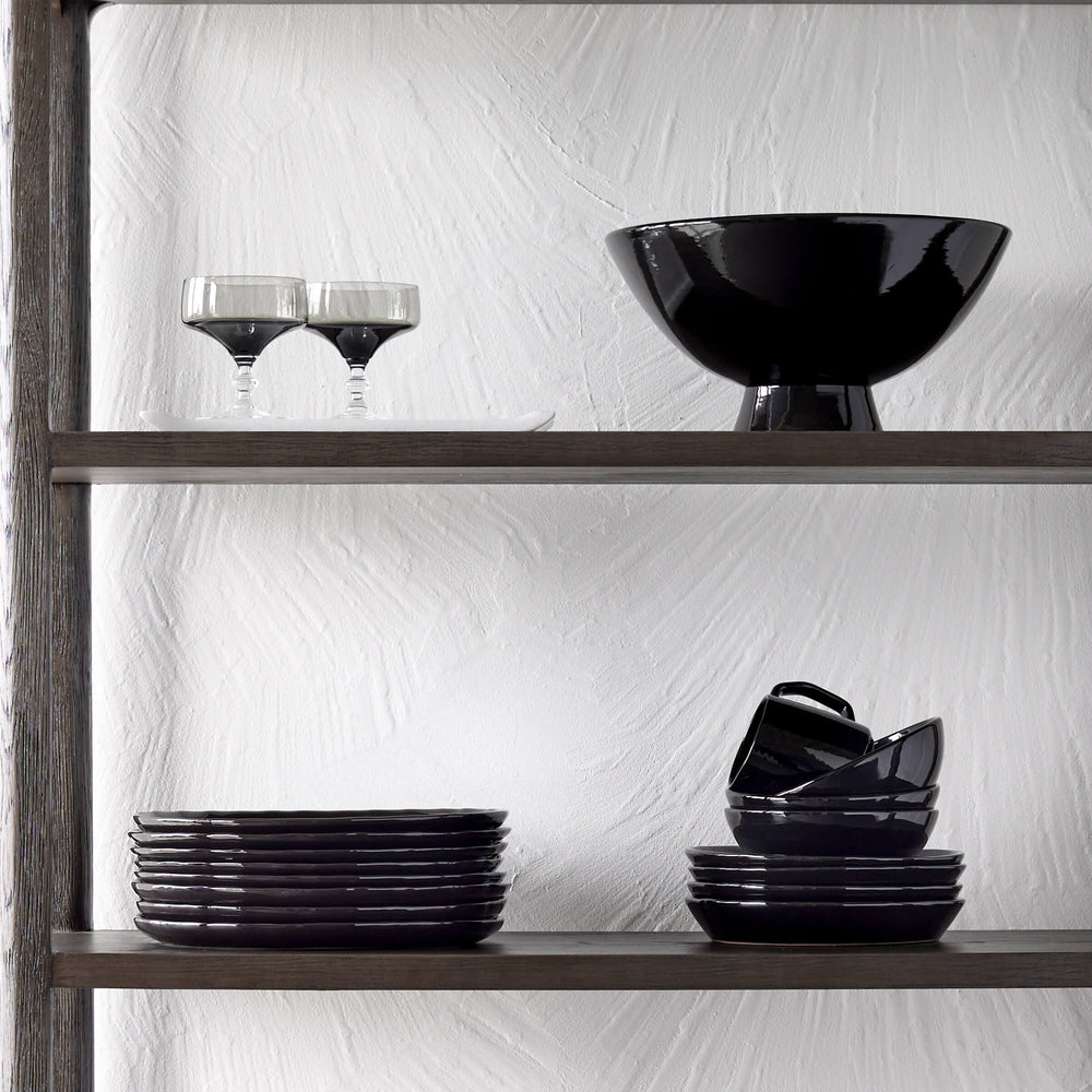 
                  
                    Modern black dinnerware on open shelves.
                  
                