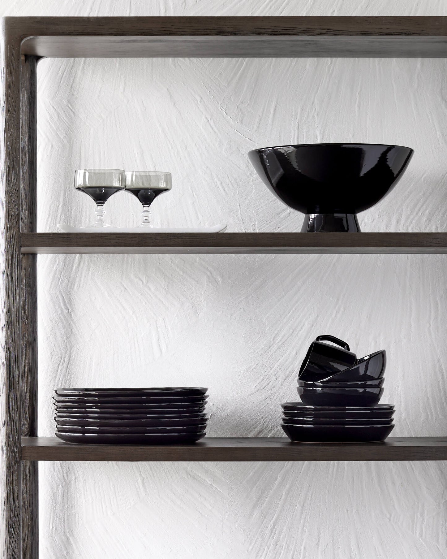 
                  
                    Modern black dinnerware on open shelves.
                  
                