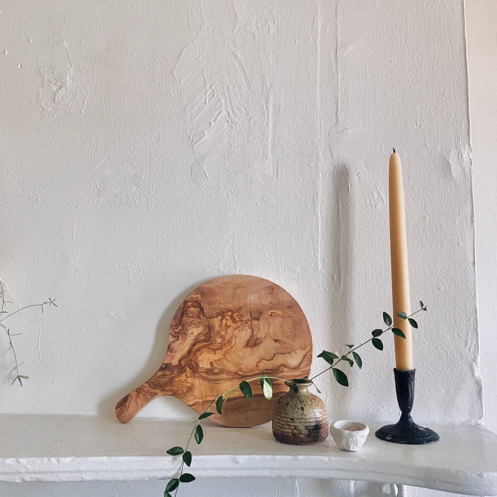 
                  
                    Marbled olive wood board set on mantle as statement decor. Photo via @hummusbirrd
                  
                