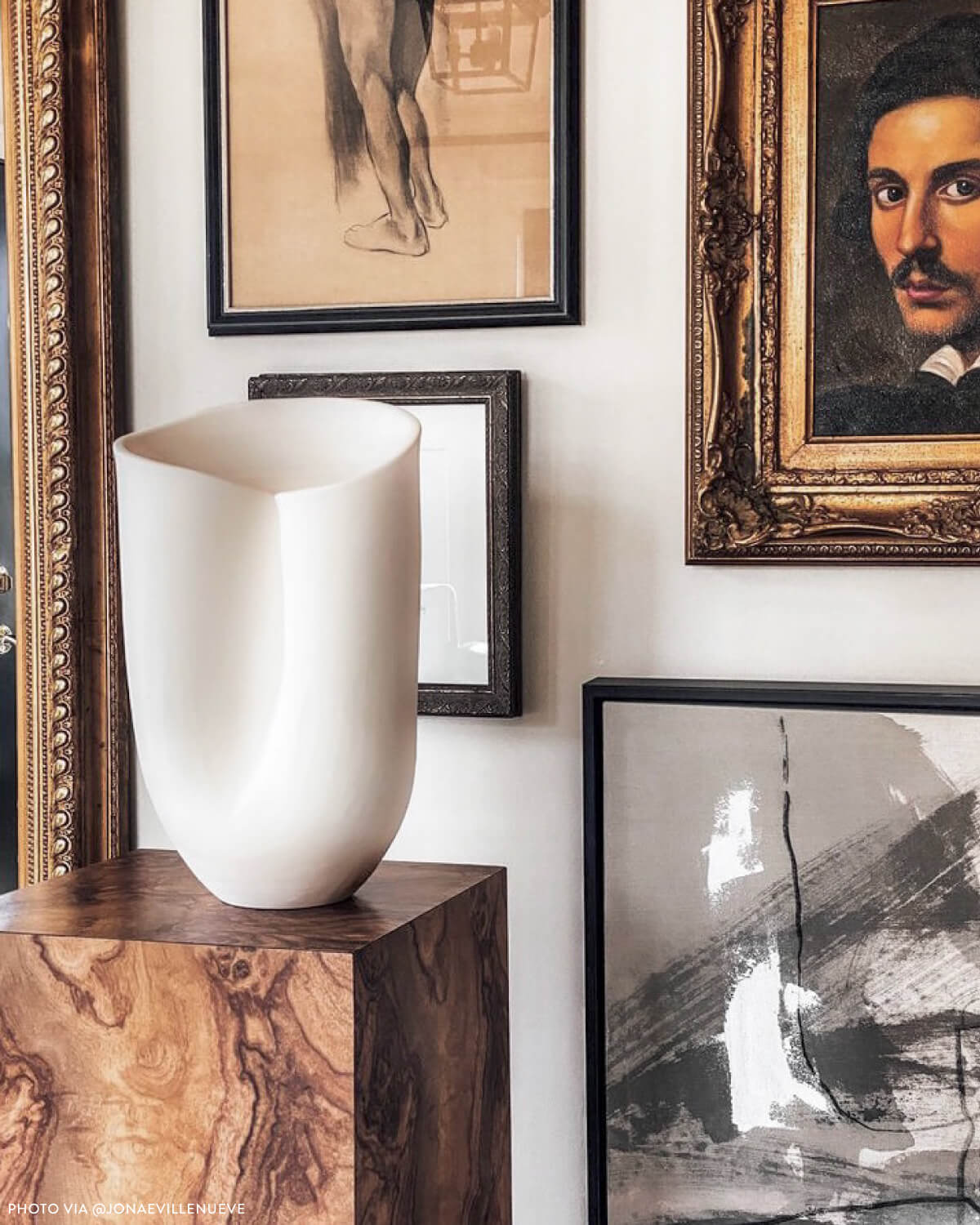 
                  
                    Large white Zoya Terracotta Vase styled on pedestal bowl against art wall. Photo via @jonaevillenueve
                  
                