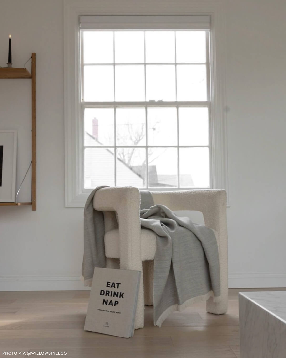 
                  
                    Gray Soñando Alpaca Throw draped on white boucle chair. Handwoven textiles ethically made in Peru.
                  
                