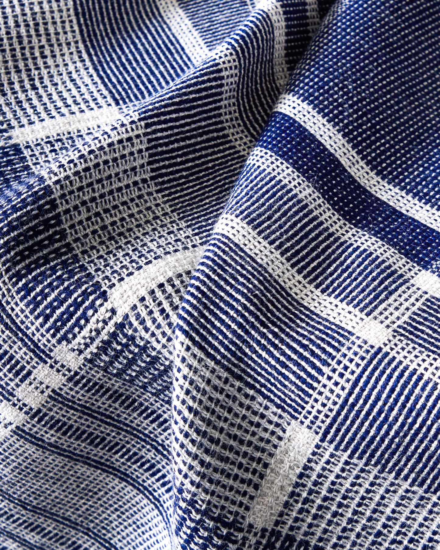 Detail of blue and white striped alpaca throw blanket. Handmade in Peru.