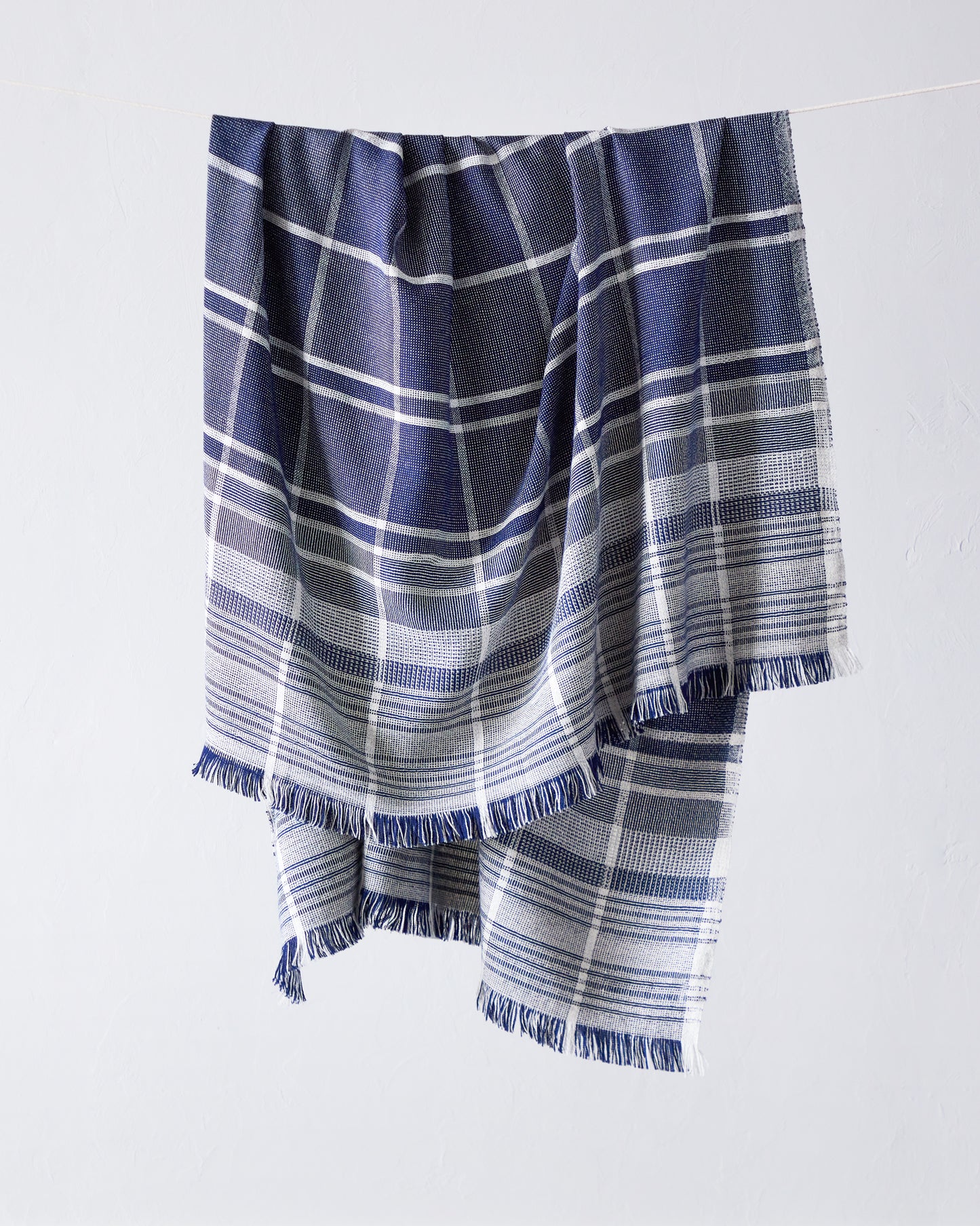 
                  
                    Fairkind Escalante navy blue white striped baby alpaca throw blanket.
                  
                