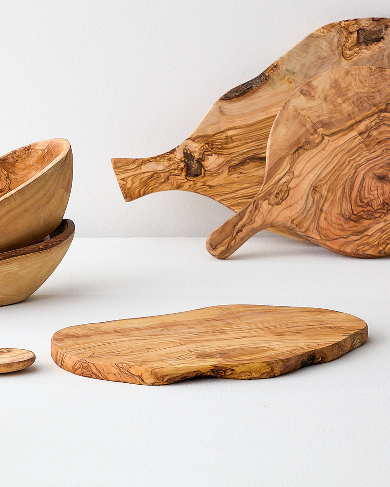 
                  
                    Collection of olive wood serving boards by Fairkind.
                  
                
