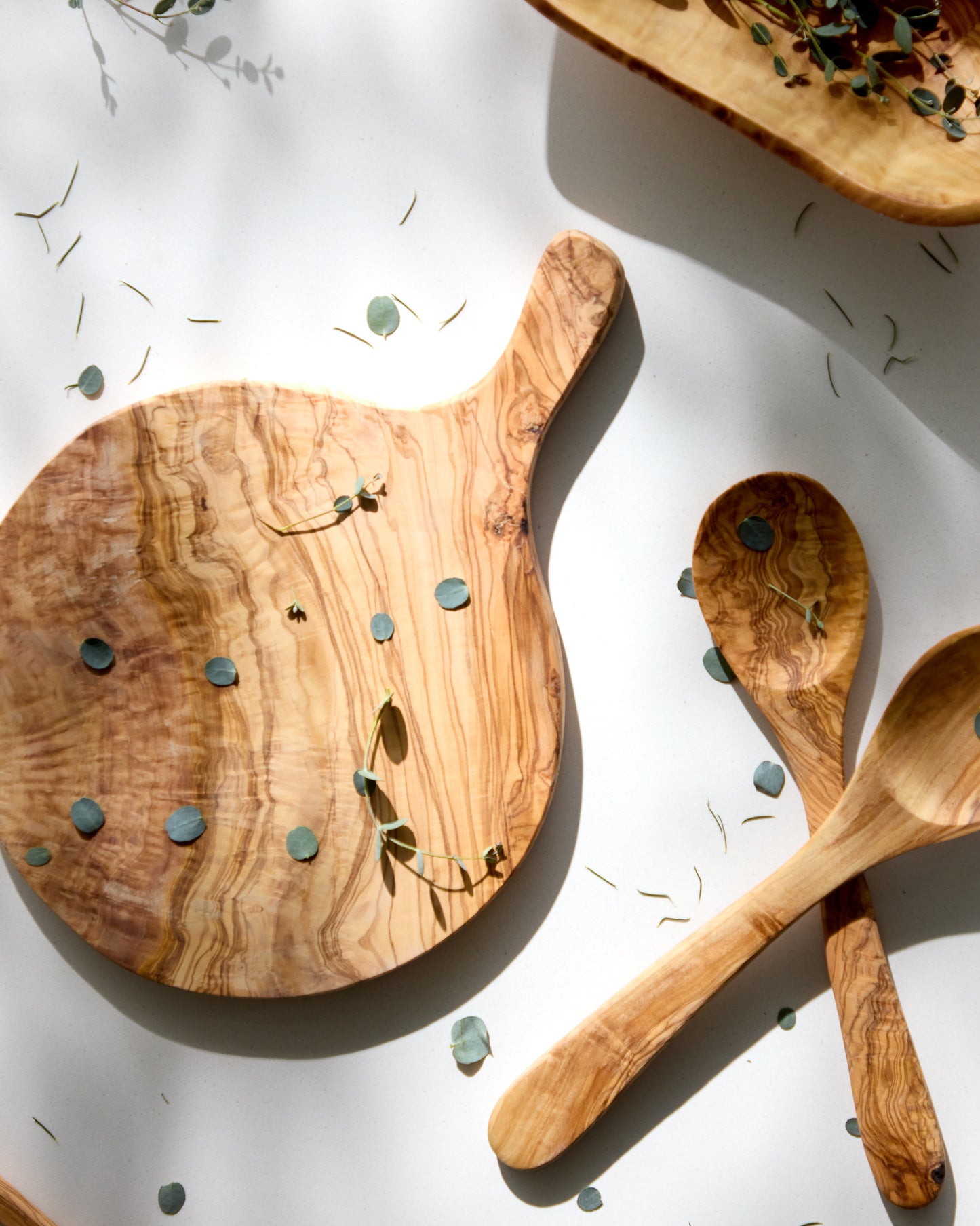 
                  
                    Handcrafted olive wood cheese board with handle.
                  
                