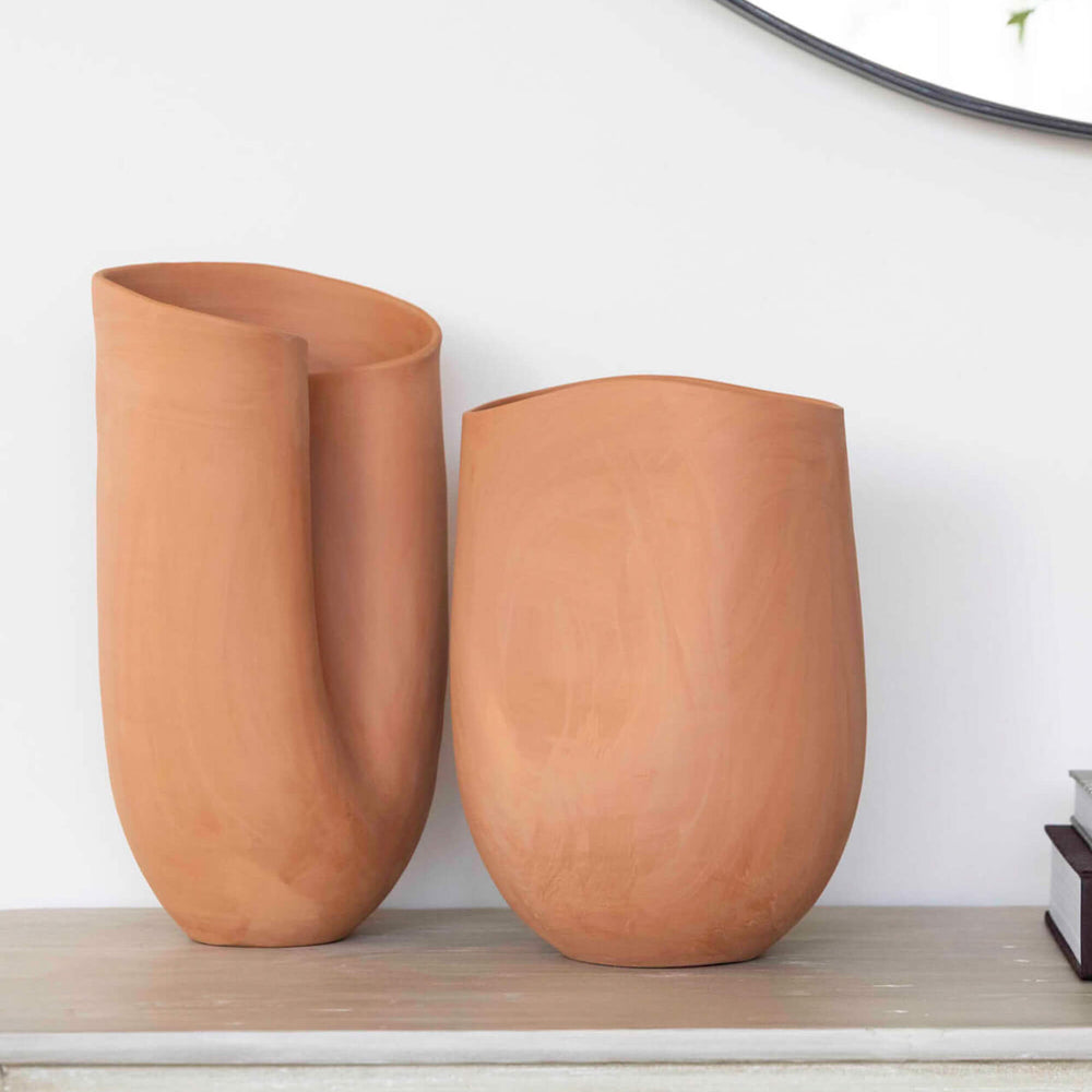 
                  
                    Handcrafted terracotta vases made in modern, sculptural style. Styled as decor on sideboard.
                  
                