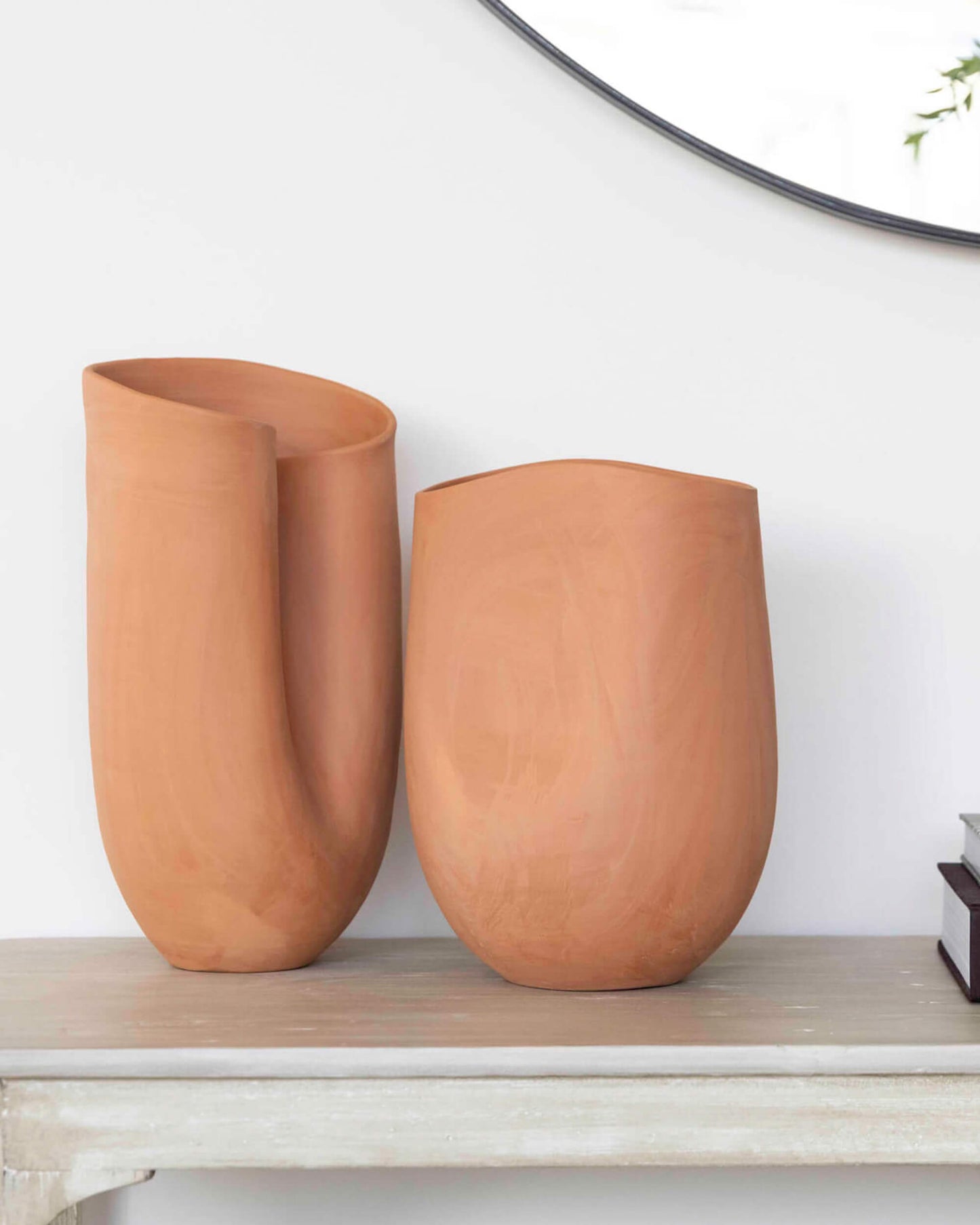 
                  
                    Handcrafted terracotta vases made in modern, sculptural style. Styled as decor on sideboard.
                  
                