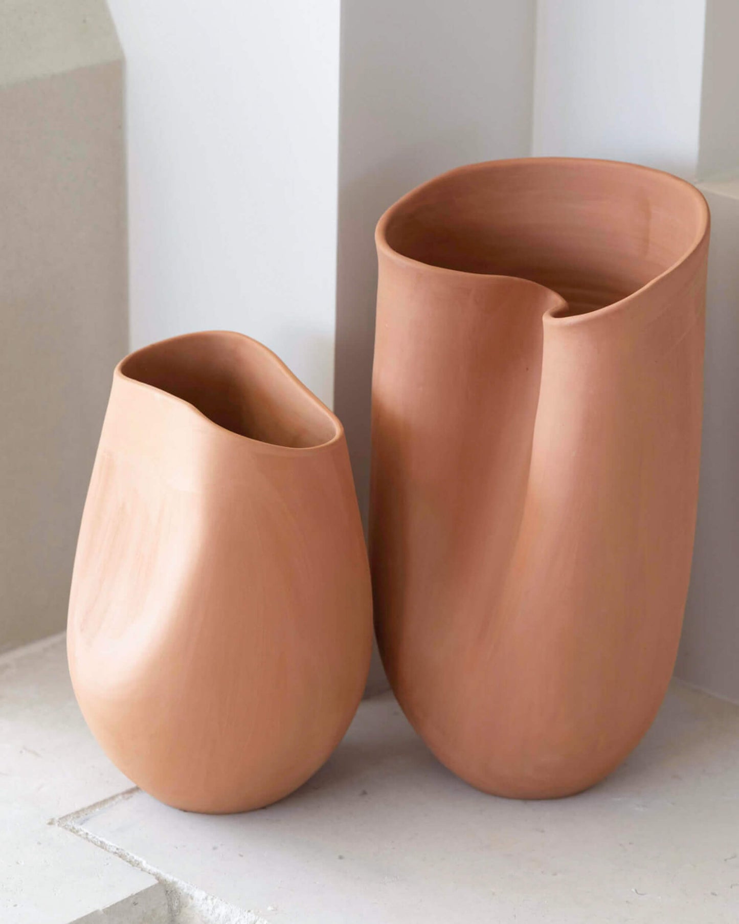 Large and small Tahj Terracotta Vases styled on stone mantle by Fairkind.