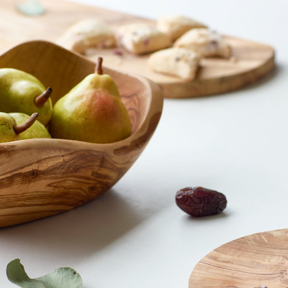 
                  
                    Holiday table spread with olive wood servingware made by master artisans in Tunisia.
                  
                