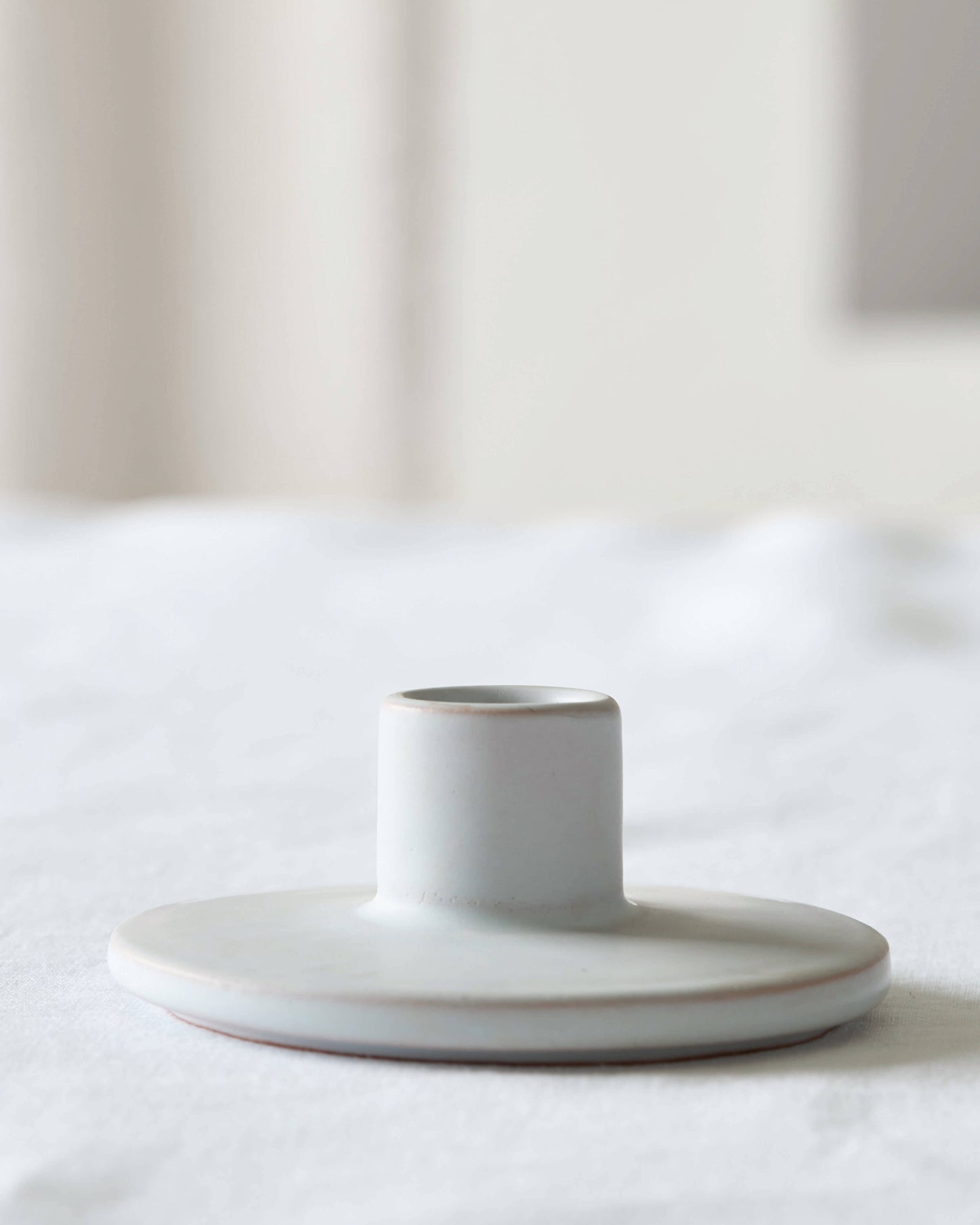 
                  
                    Minimal gray ceramic taper holder by Fairkind, handmade in Morocco by master artisans.
                  
                