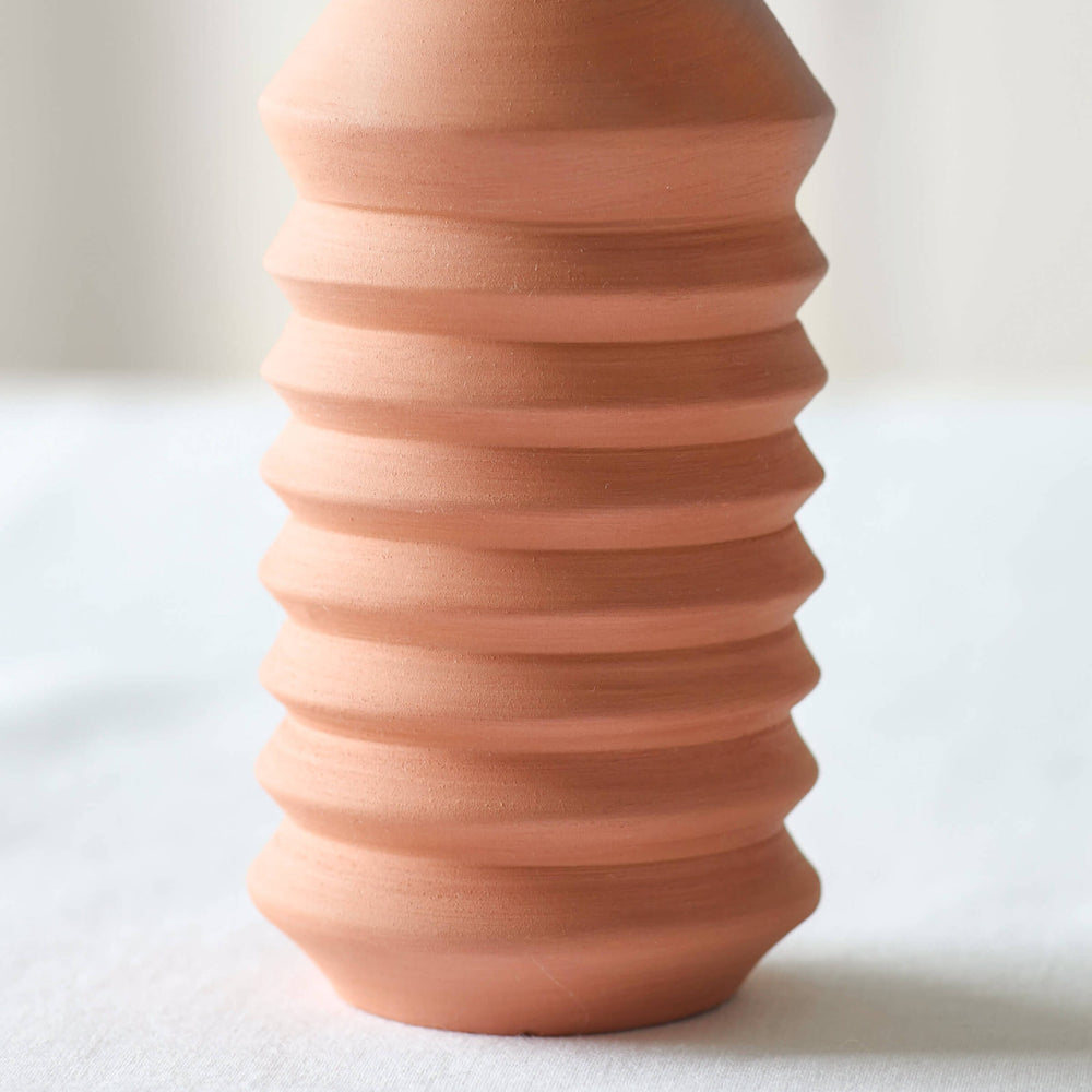 
                  
                    Large Kenza Taper Holder by Fairkind, made in Morocco with red clay in a modern, minimal design.
                  
                