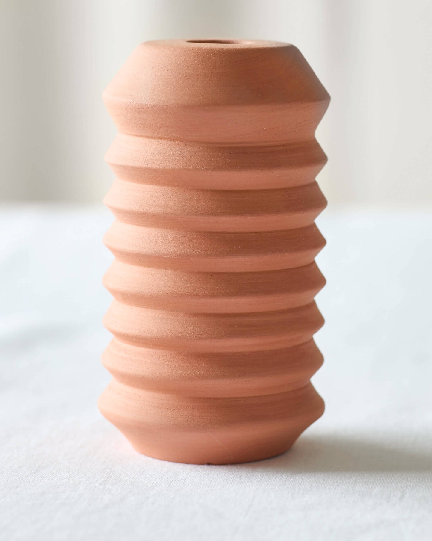
                  
                    Large Kenza Taper Holder by Fairkind, made in Morocco with red clay in a modern, minimal design.
                  
                