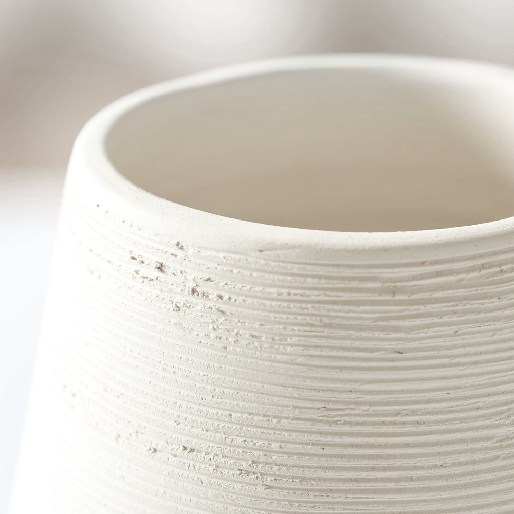 
                  
                    Close-up of Zarina Vase edge detail. Raw white clay with textured bisque finish.
                  
                