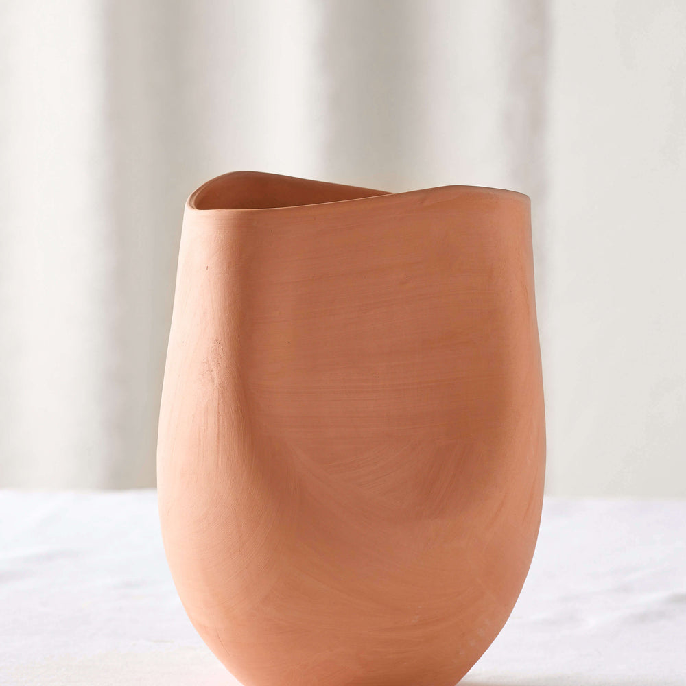 
                  
                    Small Tahj Terracotta Vase on white table. Part of Fairkind's Morocco Collection.
                  
                