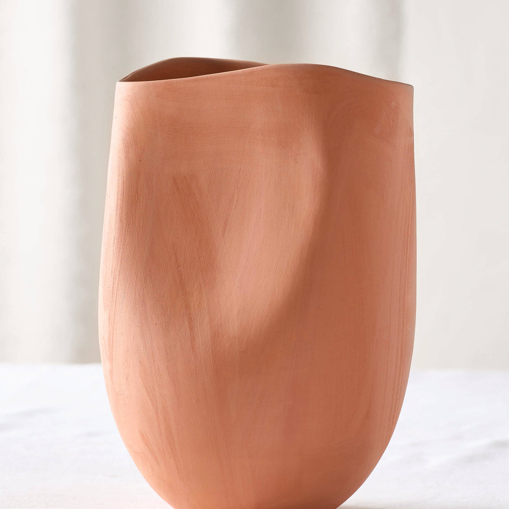 
                  
                    Medium terracotta vase on white table. Handmade in Morocco with locally-sourced clay.
                  
                